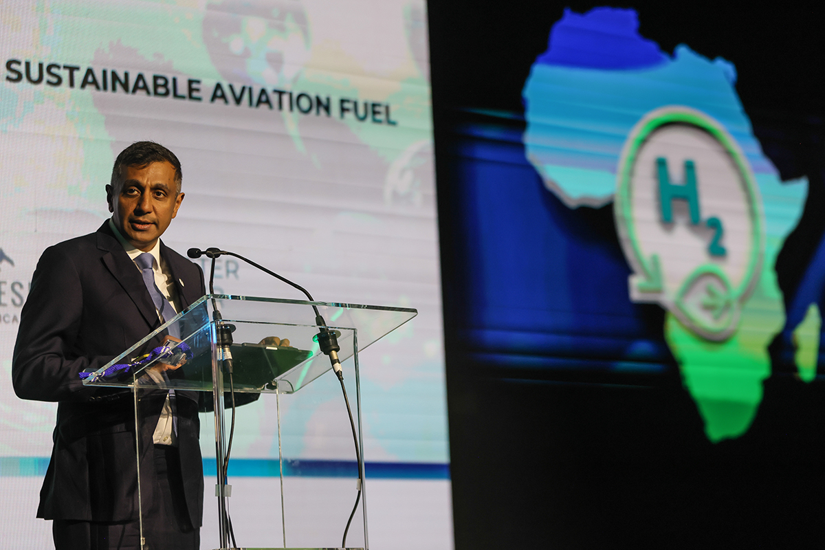 Dr Sarushen Pillay, Executive Vice President: Business Building, Strategy and Technology at Sasol, speaking at a podium during the announcement of the Sasol and White Desert Sustainable Aviation Fuel partnership at the Africa Green Hydrogen Summit in Cape Town.